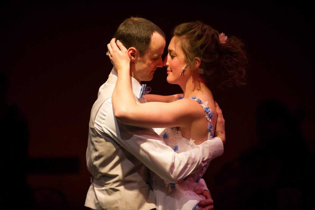 Actors portraying Jamie and Cathy in the Last Five Years embracing.