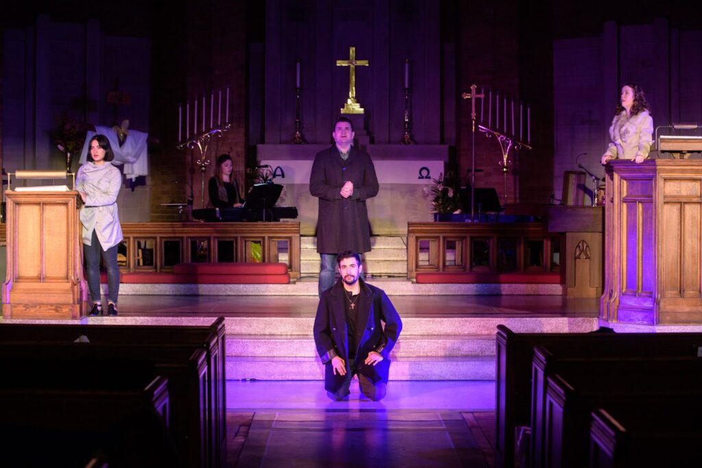 Four actors and a keyboard in a church perform a song from Songs for a New World.